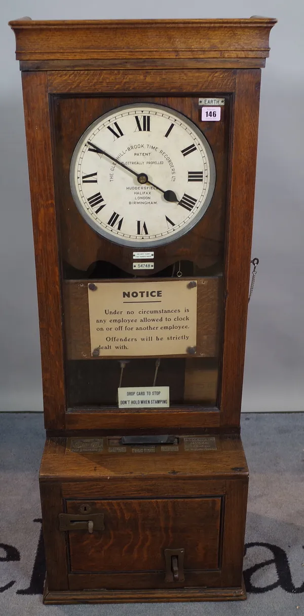 The Gledhill-Brook Time Recorders, an oak cased clocking in machine, 134cm high.