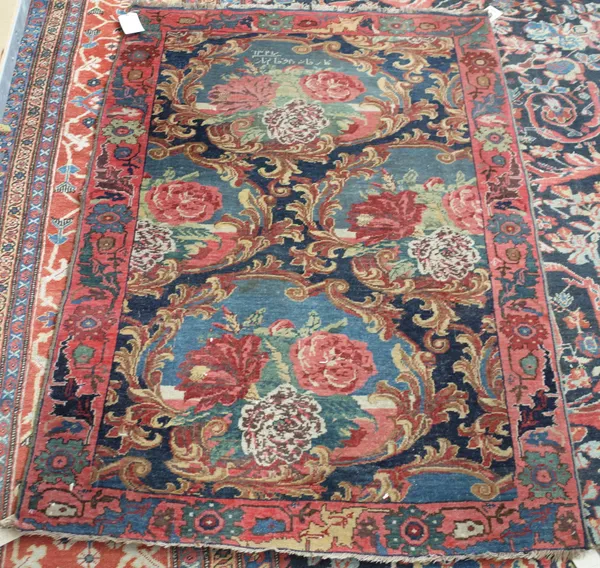 A Bidjar rug, Persian, the dark indigo field with four pale indigo carouches of naturalistic bouquets; a pale madder stylised rosette and leaf border,