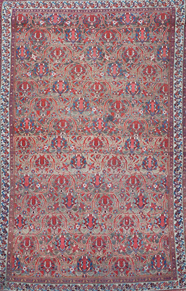 A Malayer rug, Persian, the brown field with rows of madder vines bearing simple palmette flowerheads' a simple ivory, indigo ribbon border, 196cm x 1