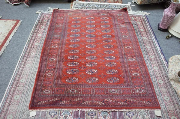 An Indian Bokhara rug, russet field, three columns, 177cm x 128cm.