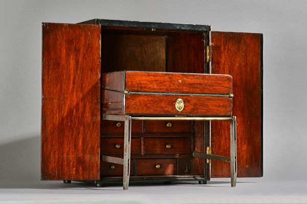 A 19th century mahogany campaign/travelling writing box, the pair of doors revealing a drop down metal frame and angled writing slope, 31cm wide x 40c