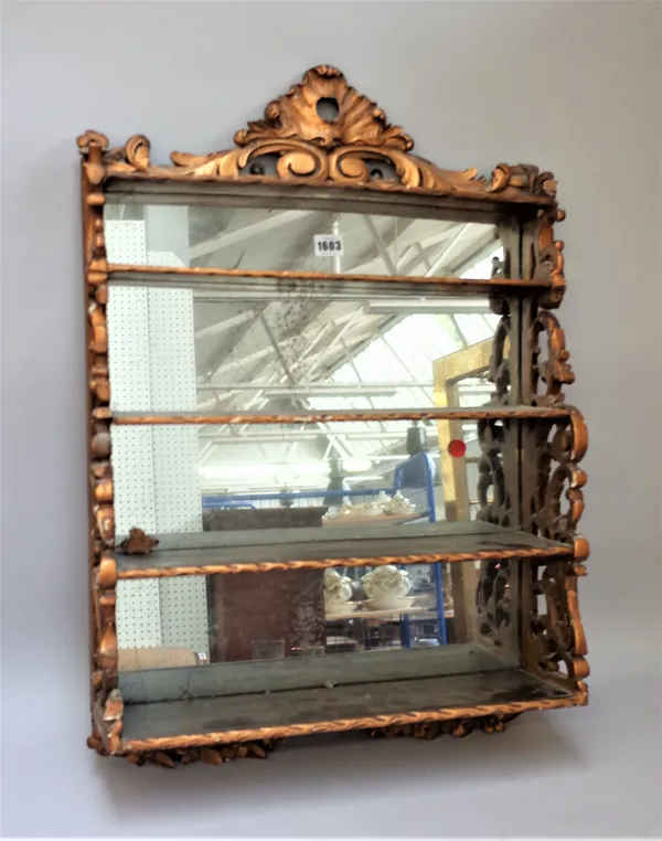 A Victorian gilt hanging waterfall four-tier wall shelf with pierced sides and mirror back, 50cm wide x 72cm high.