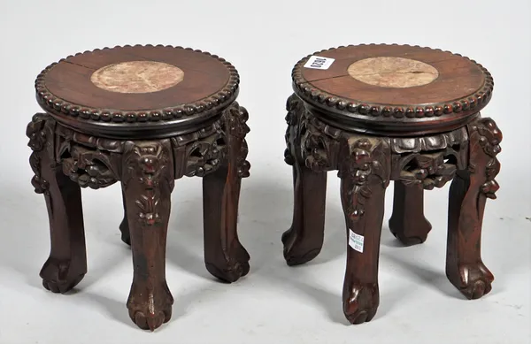 A pair of late 19th century Chinese Bonsai/ miniature jardiniere stands, each with circular marble inset tops on four carved hardwood supports, 20cm d