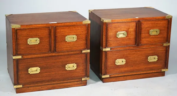 A pair of campaign style brass bound hardwood bedside cabinets each with two short over one long drawer on plinth base, 56cm wide x 50cm high.