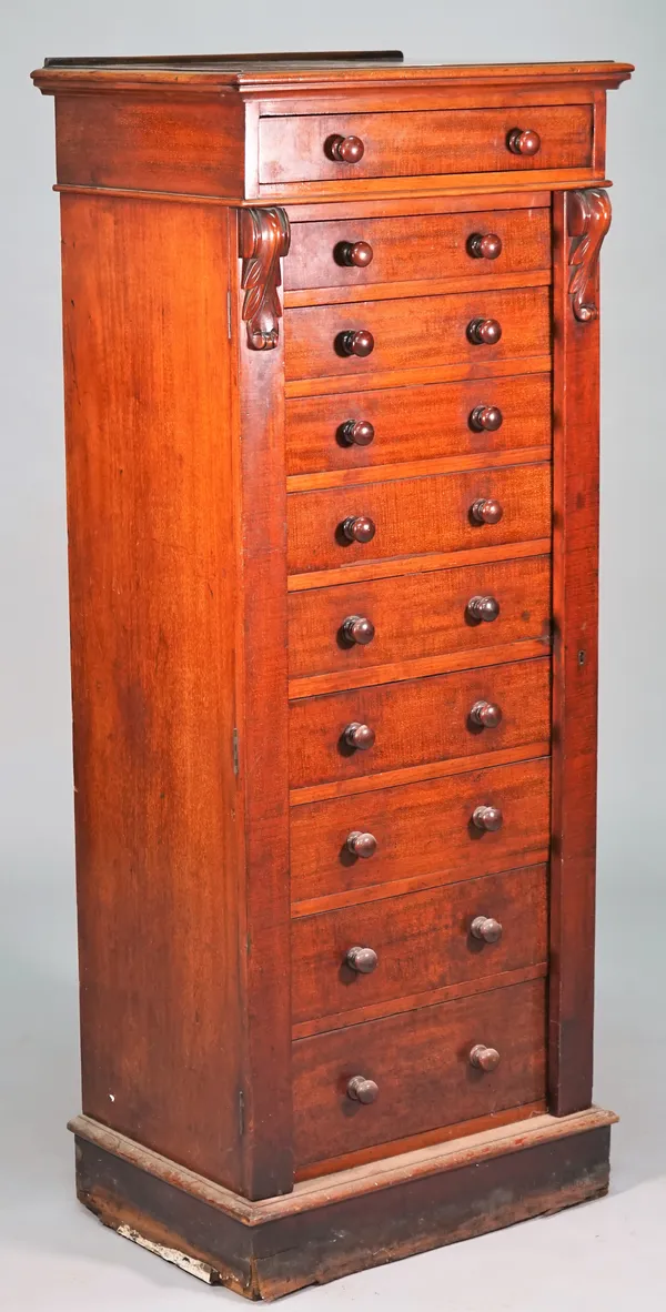 A Victorian Wellington chest with ten graduated drawers enclosed by double locking bar on plinth base, 58cm wide x 142cm high.