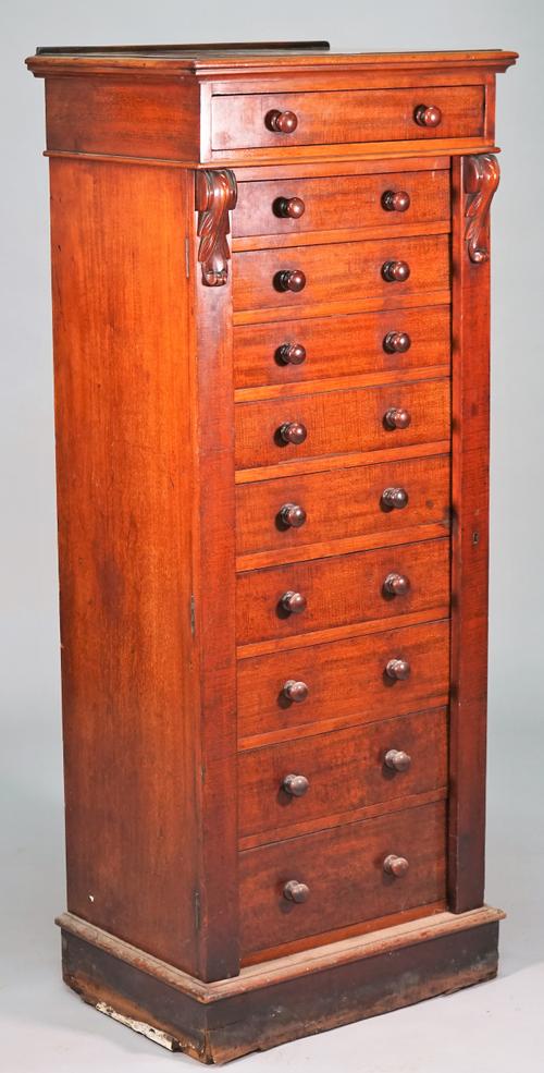 A Victorian Wellington chest with ten graduated drawers enclosed by double locking bar on plinth base, 58cm wide x 142cm high.