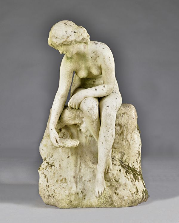 A 19th century Italian marble figure modelled as a seated water nymph, 41cm wide x 71cm high. Illustrated