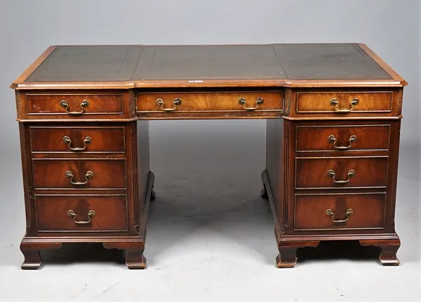 A George III style mahogany pedestal desk with nine drawers about the knee on ogee bracket feet, 154cm wide x 77cm high.