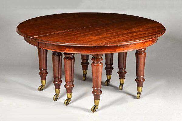 An unusual mid-19th century mahogany dual extending dining table, the circular top 153cm diameter with six halo leaves extending to 190cm diameter, al