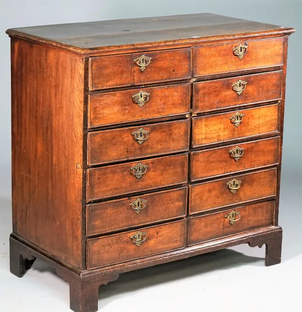 A George III oak chest with two rows of six short drawers on bracket feet, 95cm wide x 93cm high.