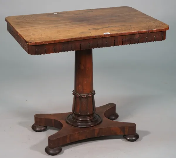 A Regency rosewood games table, the detachable rectangular top revealing a games board interior, on semi fluted column and quatrefoil platform, 83cm w