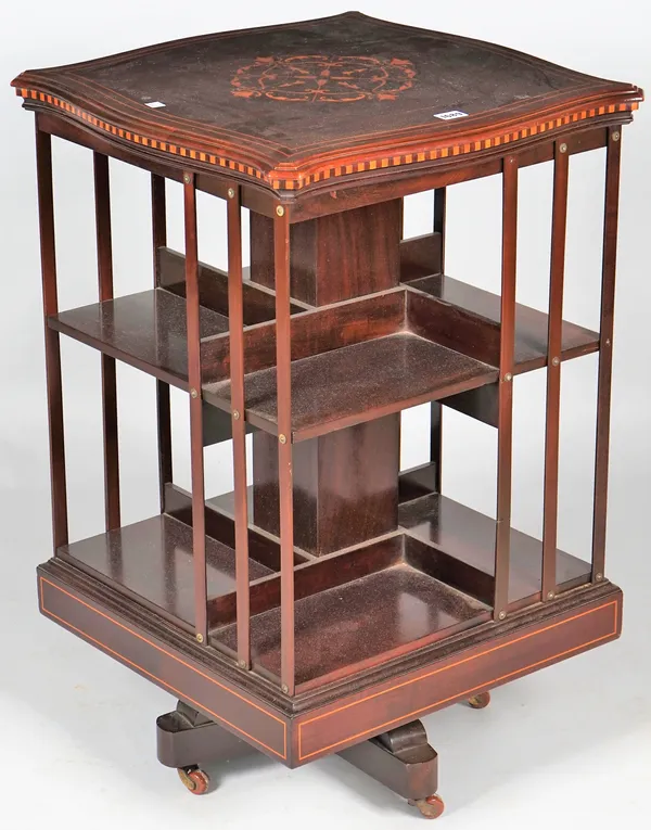 A late 19th century marquetry inlaid mahogany revolving bookcase with serpentine shaped top, 52cm wide x 84cm high.