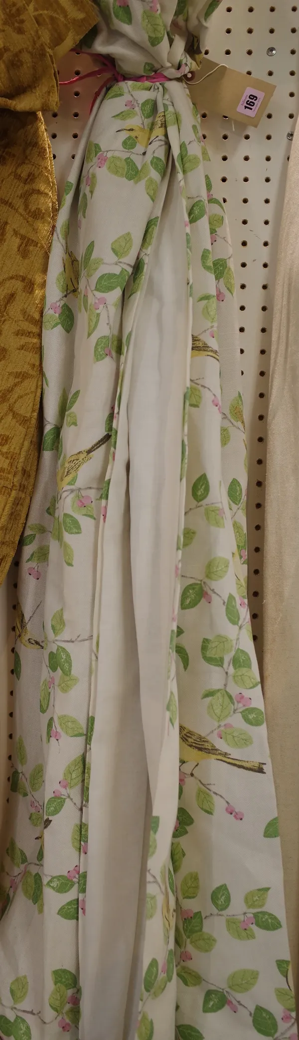 Laura Ashley; a pair of lined curtains, with green leaf and bird decoration, 70cm wide x 120cm high.