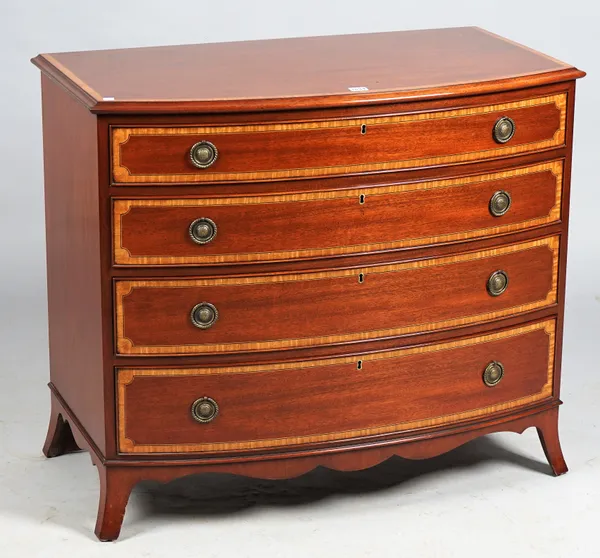 Arthur Brett; a Regency style satinwood banded mahogany bowfront chest of four long graduated drawers on splayed bracket feet, 95cm wide x 82cm high.