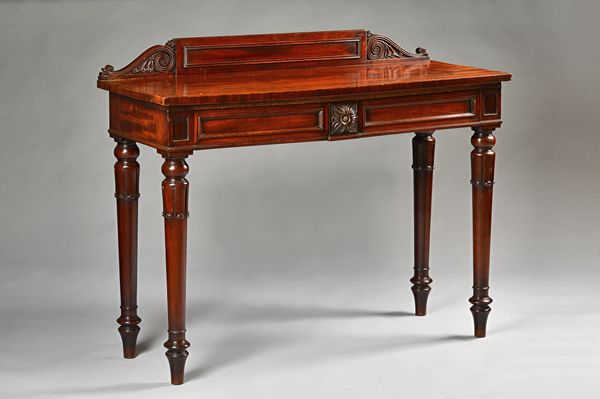 T Wilson, 68 Great Queen Street, London; a William IV mahogany scroll back serving table with a pair of frieze drawers on lappet carved supports, 130c