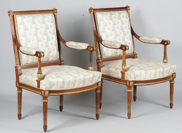 A pair of Louis XVI style gilt metal mounted square back open armchairs with bow seat on tapering fluted supports, 65cm wide x 96cm high, (2).