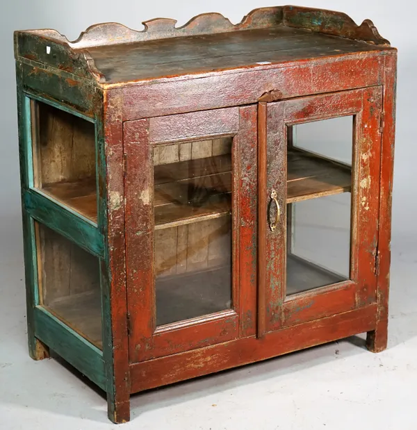 A  painted hardwood side cabinet, the shaped three quartered galleried top over glass doors and sides, on block feet, 83cm wide x 88cm high.