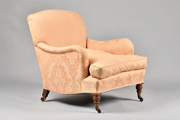 Howard & Son; an easy armchair with downswept arms and shaped side frieze on turned supports, castors and back leg both stamped, 75cm wide x 85cm high