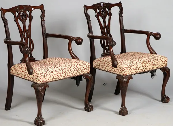 A pair of George II style mahogany open armchairs with pierced splat back and ball and claw arm supports and feet, 75cm wide x 101cm high.