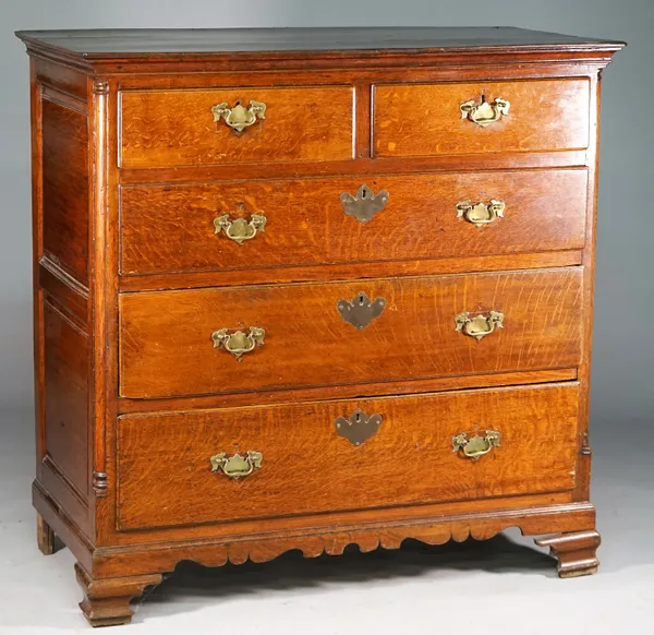 A mid-18th century Lancashire oak chest of two short over three long graduated drawers flanked by rounded corners on ogee bracket feet, 122cm wide x 1