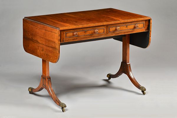 A Regency rosewood sofa table, with a pair of yew lined frieze drawers and dummy opposing, on four downswept supports, 100cm wide x 73cm high. Illustr