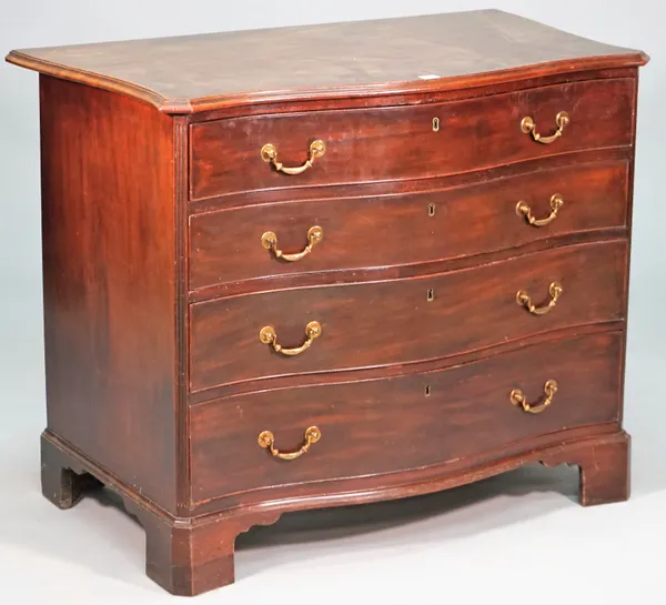 A George III mahogany serpentine dressing chest of four long graduated drawers, on bracket feet, the top drawer revealing a fitted interior, 97cm wide