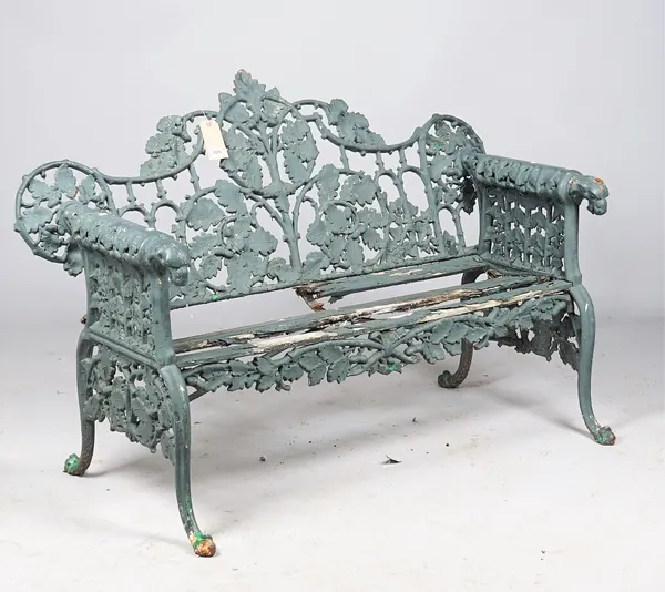 After Coalbrookdale; an oak and ivy pattern green painted cast iron garden bench, 150cm wide x 99cm high.