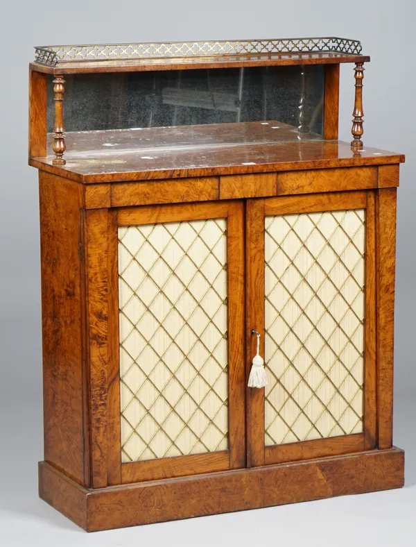 An early Victorian pollard oak side cabinet with mirrored ledge back over a pair of brass grille doors on plinth base, 90cm wide x 117cm high.