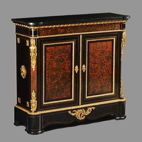 A Napoleon III ormolu mounted boulle and ebonised side cabinet, the black marble top with out stepped rounded corners over a pair of panel doors flank