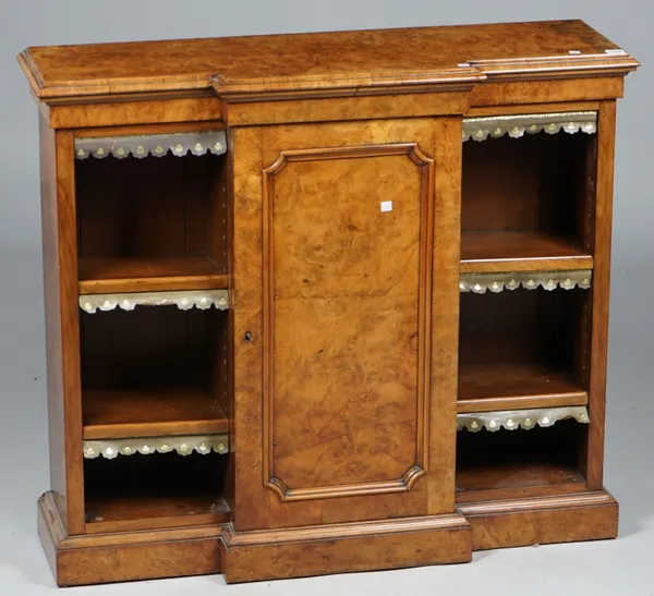 A Victorian figured walnut floor standing bookcase with central panel cupboard, flanked by open shelves on plinth base, 106cm wide x 92cm high.