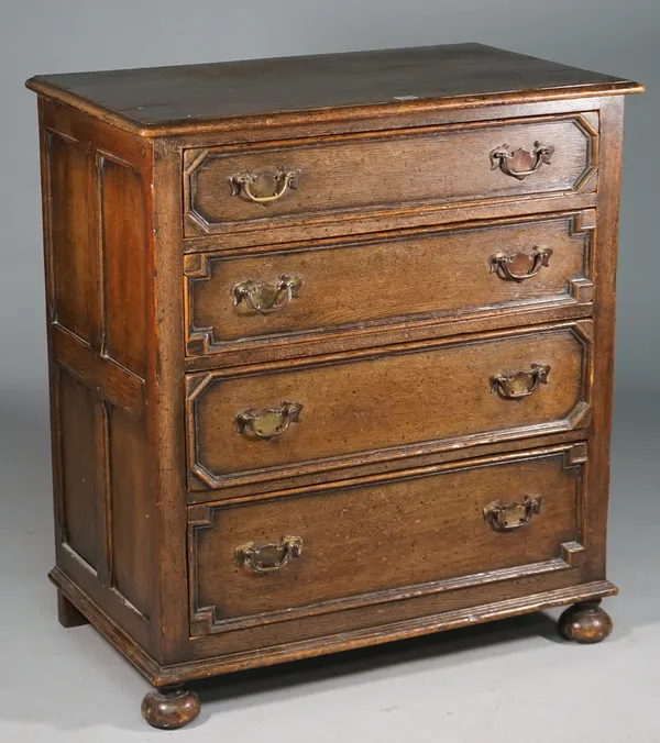 A Charles II style oak chest with four long graduated geometric moulded drawers on bun feet, 80cm wide x 90cm high.