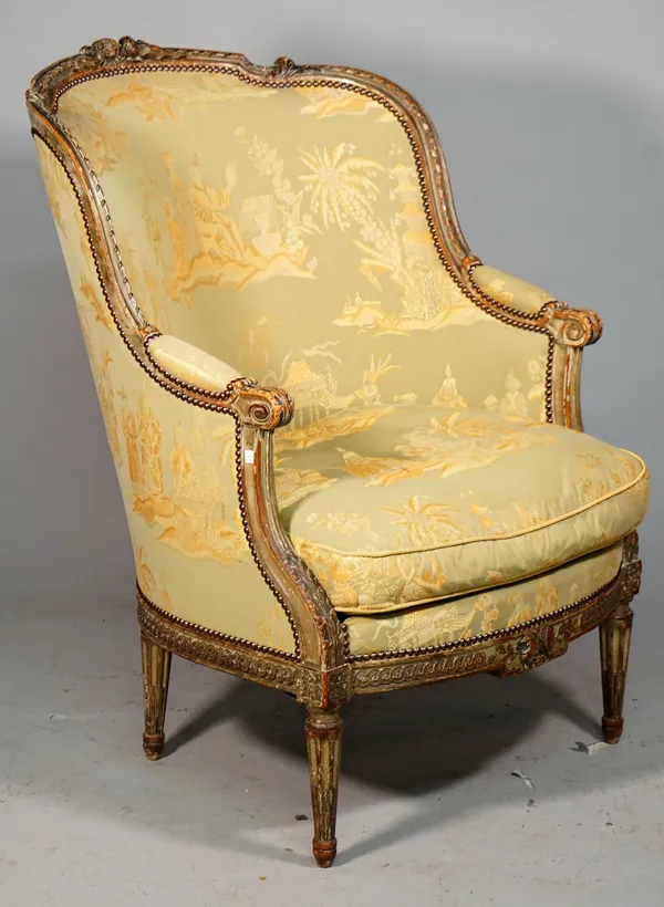 A Louis XVI style tub back armchair with foliate carved green painted frame on tapering fluted supports, 19th century, 73cm wide x 102cm high.