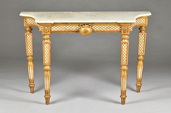 An early 19th century Italian console, the marble top with swept sides, the parcel gilt base with blind lattice frieze centred by a medallion, on squa