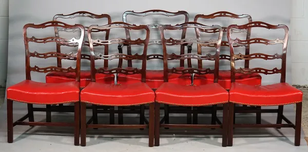 A set of seven George II style mahogany ribbon back dining chairs with concave seat on canted square supports, one carver, (7).