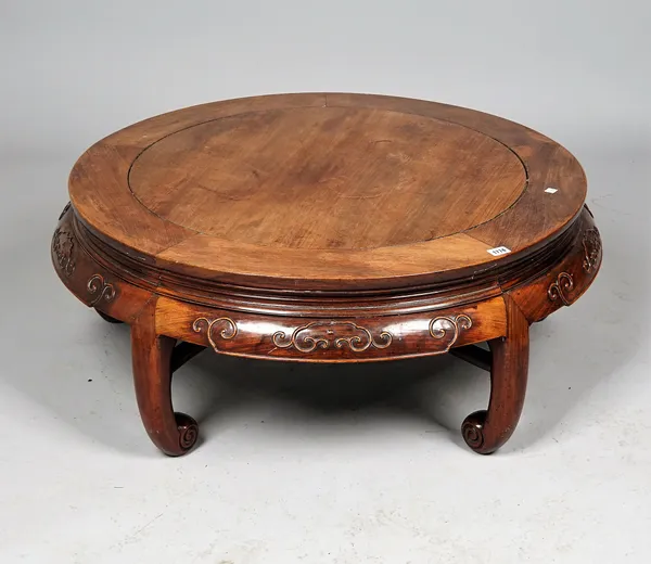 An early 20th century Chinese hardwood circular low table on five inswept supports, united by shaped stretcher, 96cm diameter x 38cm high.