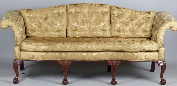 A George II style sofa with hump back, roll over arms and serpentine seat on four claw and ball feet, 220cm wide x 90cm high.