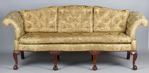 A George II style sofa with hump back, roll over arms and serpentine seat on four claw and ball feet, 220cm wide x 90cm high.