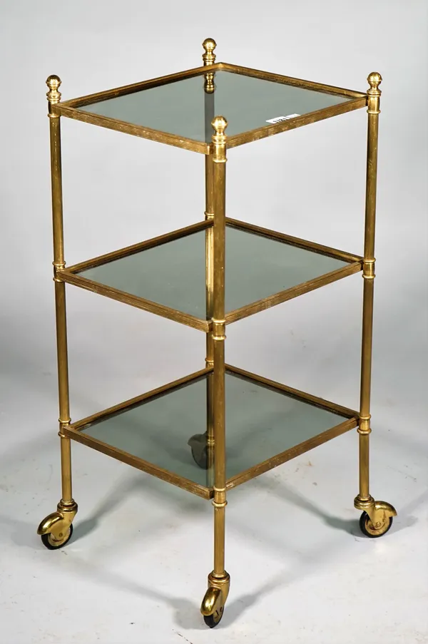 A mid-20th century lacquered brass and smoked glass three tier etagere, on reeded supports, 32cm wide x 68cm high.