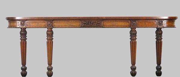 A William IV mahogany console, the shallow 'D' shape top on four foliate carved tapering reeded supports, 272cm wide x 93cm high.