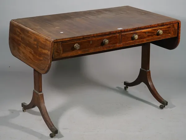 A George III mahogany sofa table, the pair of frieze drawers on slab trestle end standards with four downswept supports, 109cm wide x 72cm high.