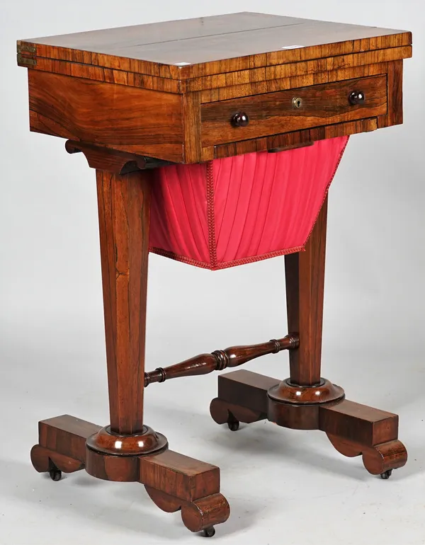 A Regency rosewood work/ games table, the pivoting top revealing a Backgammon board over fitted frieze drawer and wool box on tapering hexagonal suppo