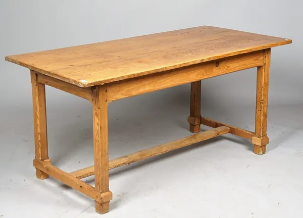 A 19th century pine kitchen table, the single plank top on four canted square supports, 77cm wide x 165cm long.