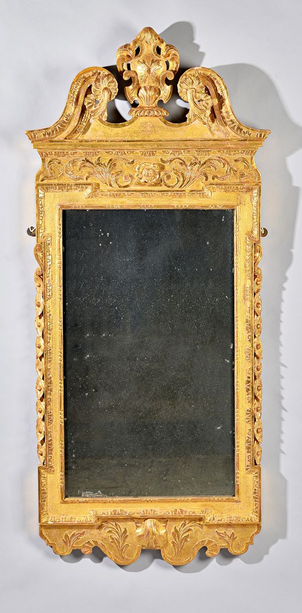 A George II gilt framed mirror, the broken swan neck crest centred by a cartouche over floral chased frame and shell lower frieze, 63cm wide x 141cm h