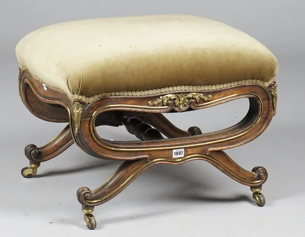 A 19th century Italian gilt-metal mounted walnut foot stool, the over stuffed rectangular top on dual 'X' frame supports united by turned stretcher, 5