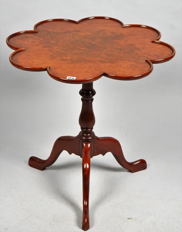 A mid-18th century style burr walnut supper table, the lobed circular top on bird cage mount and tripod base, 68cm wide x 68cm high.