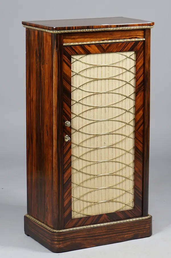 An early Victorian gilt-metal mounted coromandel side cabinet, with single grille door on plinth base, 59cm wide x 112cm high.