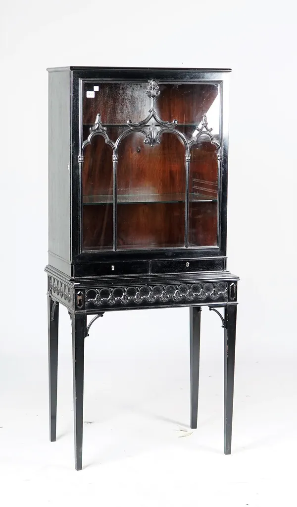 An ebonised display cabinet, with glazed door over pair of drawers on tapering square supports, 72cm wide x 164cm high.