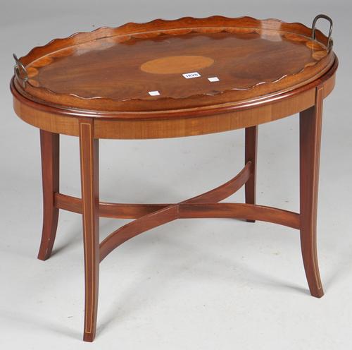A George III satinwood inlaid mahogany oval serving tray with wavy gallery on later stand, 69cm wide x 58cm high.