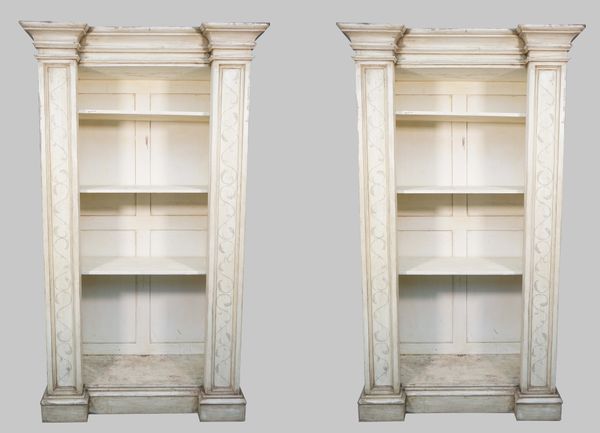 A pair of distressed white painted floor standing breakfront open bookcases, each on plinth base, 120cm wide x 210cm high, (2).