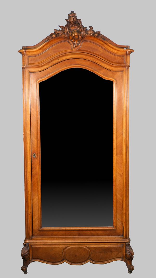 A late 19th century French walnut and kingwood armoire, with acanthus carved crest over bevelled mirrored door, on scroll feet, 106cm wide x 247cm hig